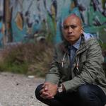 DOSA posing in front of graffiti